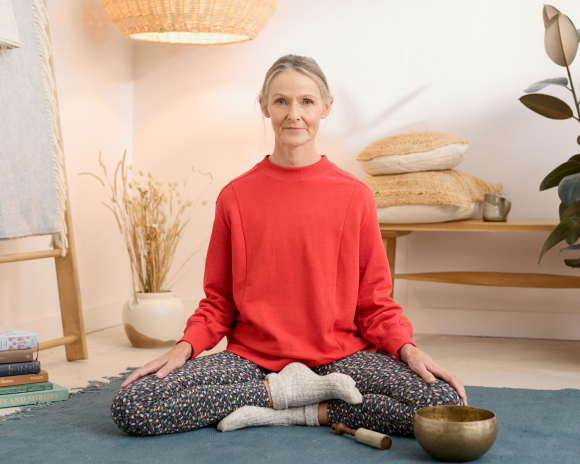 Woman sat in yoga position practicing mindfulness