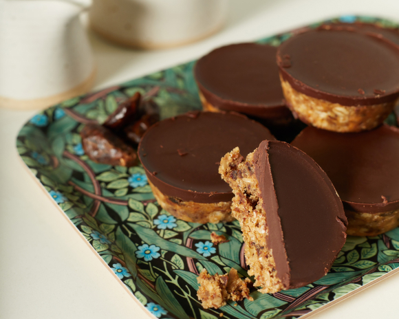 Chocolate covered peanut butter cups on a green floral plate