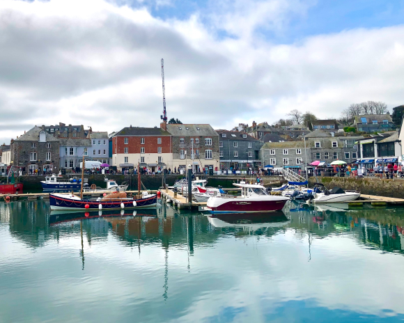 A harbour filled with small boats and buildings in the background