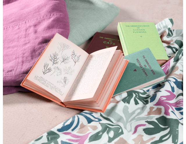 Printed fabrics with books scattered across them